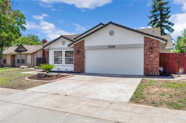 1534 Princeton Ave, Madera, CA 93637 - single story home featuring brick siding, an attached garage, concrete driveway, and a tile roof