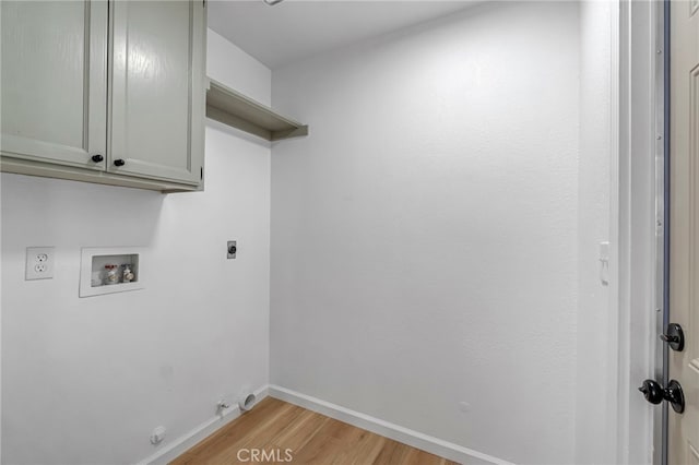 1534 Princeton Ave, Madera, CA 93637 - washroom featuring electric dryer hookup, washer hookup, light wood finished floors, hookup for a gas dryer, and cabinet space