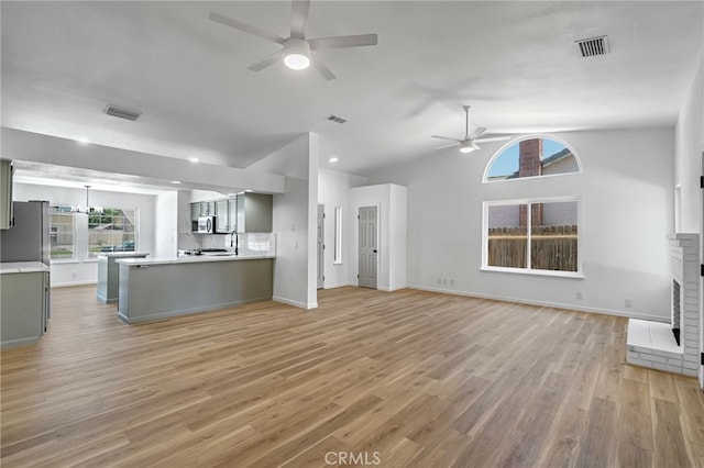 1534 Princeton Ave, Madera, CA 93637 - unfurnished living room featuring ceiling fan, light wood-type flooring, and vaulted ceiling