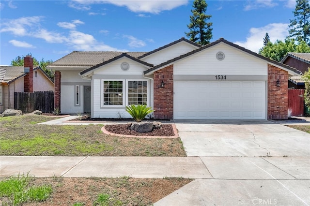 1534 Princeton Ave, Madera, CA 93637 - ranch-style house featuring an attached garage, brick siding, driveway, and a tile roof