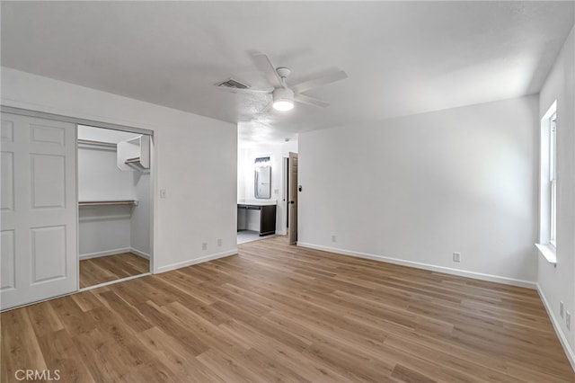 1534 Princeton Ave, Madera, CA 93637 - unfurnished bedroom featuring light wood-type flooring, multiple windows, and ensuite bathroom
