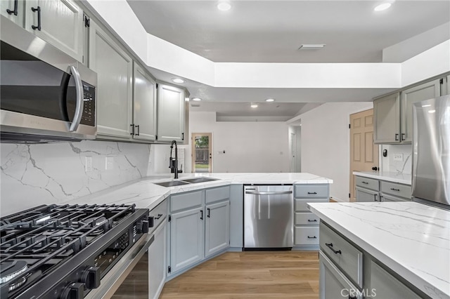 1534 Princeton Ave, Madera, CA 93637 - kitchen with appliances with stainless steel finishes, gray cabinets, recessed lighting, and light wood-style flooring