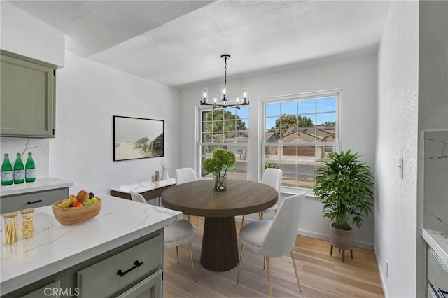 1534 Princeton Ave, Madera, CA 93637 - dining space with a chandelier, light wood-style flooring, and a textured ceiling
