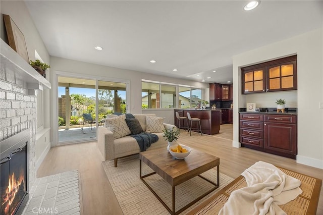2260 Ardemore Dr, Fullerton, CA 92833 - living area featuring a fireplace, light wood-type flooring, and recessed lighting