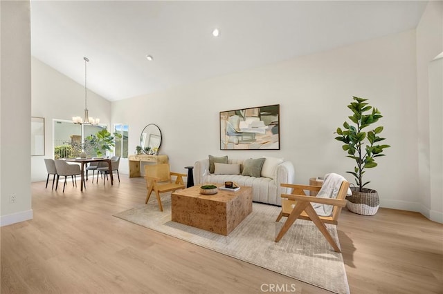 2260 Ardemore Dr, Fullerton, CA 92833 - living area with light wood-style flooring, a chandelier, high vaulted ceiling, and recessed lighting