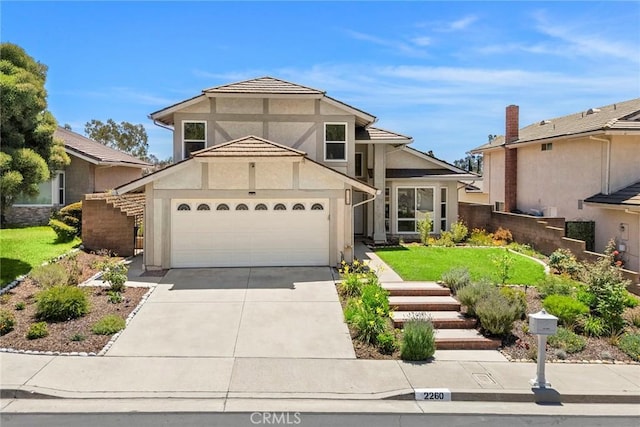 2260 Ardemore Dr, Fullerton, CA 92833 - view of front of property featuring concrete driveway, stucco siding, and a garage