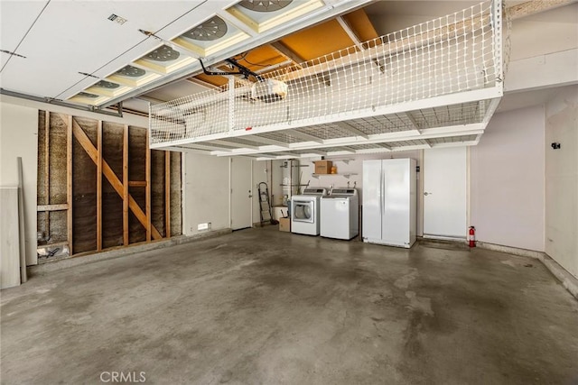 2260 Ardemore Dr, Fullerton, CA 92833 - garage featuring separate washer and dryer and freestanding refrigerator