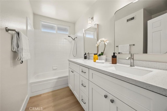 2260 Ardemore Dr, Fullerton, CA 92833 - full bathroom featuring double vanity, shower / tub combination, and wood finished floors
