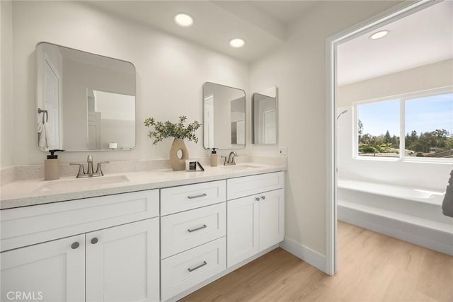 2260 Ardemore Dr, Fullerton, CA 92833 - bathroom with double vanity, a garden tub, recessed lighting, and wood finished floors