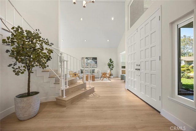 2260 Ardemore Dr, Fullerton, CA 92833 - entryway featuring high vaulted ceiling, stairs, and wood finished floors