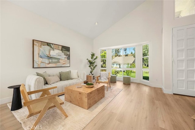 2260 Ardemore Dr, Fullerton, CA 92833 - living room featuring high vaulted ceiling and light wood-style flooring