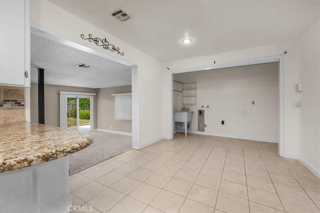404 W Robinson Ave, Fresno, CA 93705 - kitchen featuring light countertops, white cabinets, light tile patterned floors, backsplash, and open floor plan