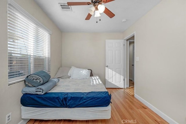 404 W Robinson Ave, Fresno, CA 93705 - bedroom with light wood-style flooring and a ceiling fan