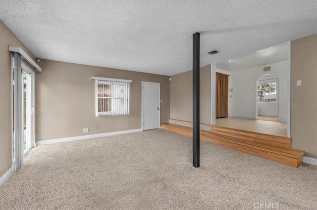 404 W Robinson Ave, Fresno, CA 93705 - unfurnished living room featuring carpet flooring and a textured ceiling