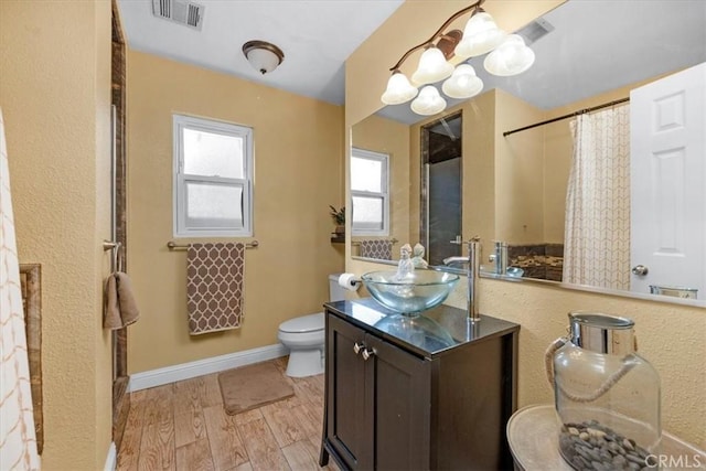 404 W Robinson Ave, Fresno, CA 93705 - bathroom with vanity, curtained shower, wood finished floors, and a chandelier