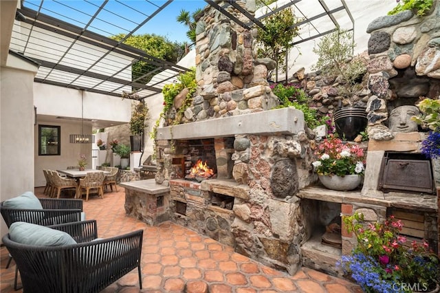 2570 Queda Way, Laguna Beach, CA 92651 - view of patio / terrace featuring an outdoor stone fireplace, outdoor dining space, and a pergola