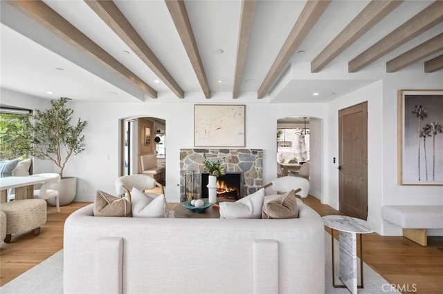 2570 Queda Way, Laguna Beach, CA 92651 - living room featuring arched walkways, light wood-type flooring, beamed ceiling, a fireplace, and recessed lighting