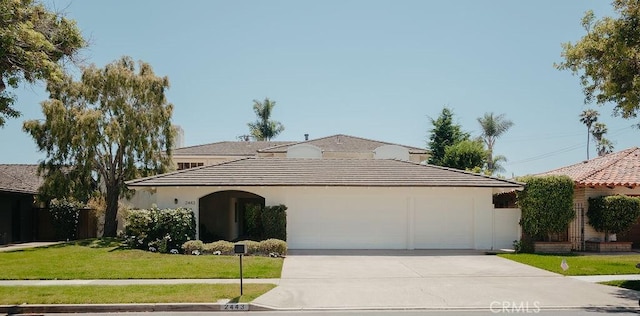 2443 Windward Ln, Newport Beach, CA 92660 - view of front facade with concrete driveway, a garage, stucco siding, and a tile roof