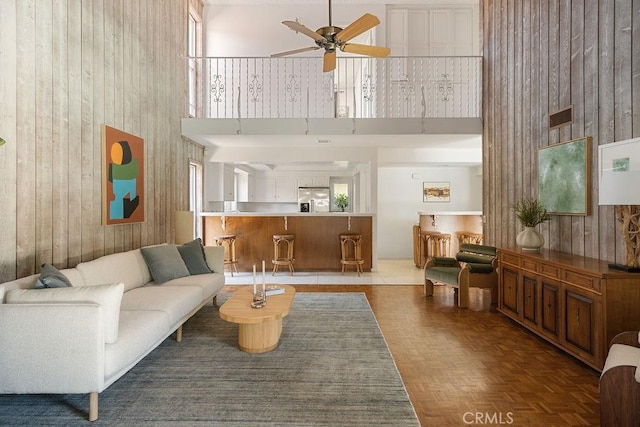 2443 Windward Ln, Newport Beach, CA 92660 - living room featuring a high ceiling, ceiling fan, and wood walls