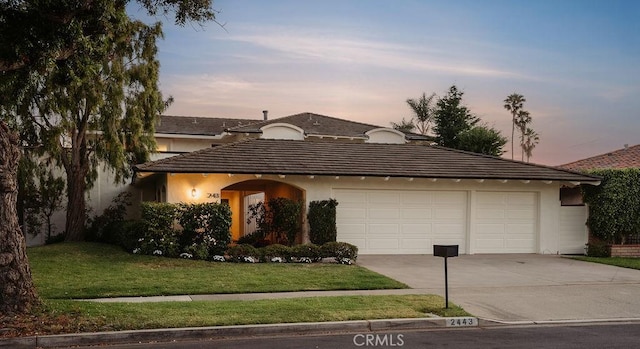 2443 Windward Ln, Newport Beach, CA 92660 - view of front of home with a tiled roof, driveway, stucco siding, a front lawn, and a garage