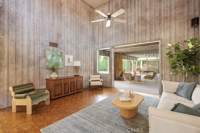 2443 Windward Ln, Newport Beach, CA 92660 - living area featuring wood walls, a high ceiling, and a ceiling fan