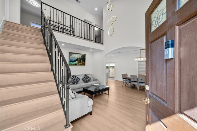 18340 Keswick St Unit 5, Reseda, CA 91335 - entryway with arched walkways, a high ceiling, stairway, and wood finished floors