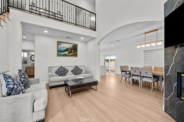 18340 Keswick St Unit 5, Reseda, CA 91335 - living area with arched walkways, wood finished floors, a high ceiling, and stairs