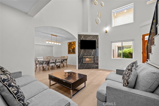 18340 Keswick St Unit 5, Reseda, CA 91335 - living area with a towering ceiling, wood finished floors, and a fireplace