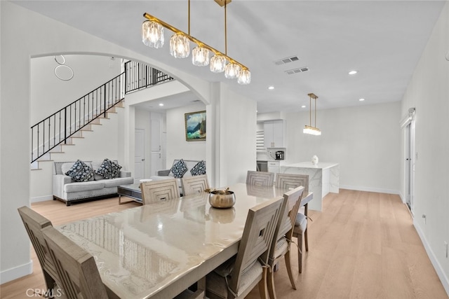 18340 Keswick St Unit 5, Reseda, CA 91335 - dining space with light wood finished floors, arched walkways, stairway, and recessed lighting