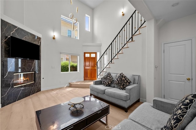 18340 Keswick St Unit 5, Reseda, CA 91335 - living room featuring wood finished floors, stairs, a high end fireplace, and a high ceiling
