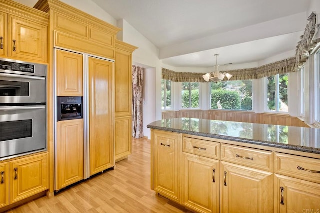 61 Via Larga Vis, Bonsall, CA 92003 - kitchen featuring paneled built in fridge, double oven, light wood-type flooring, a chandelier, and dark stone countertops