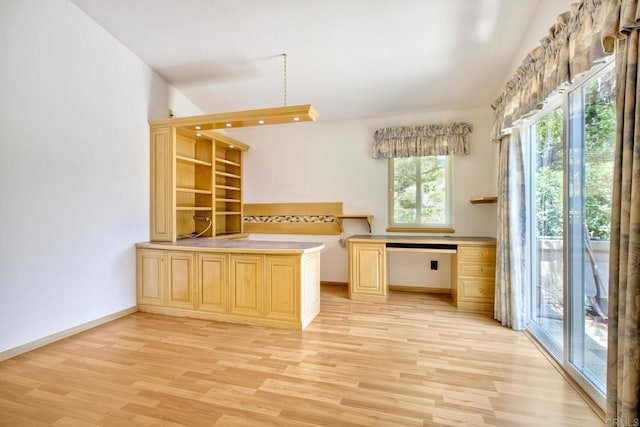 61 Via Larga Vis, Bonsall, CA 92003 - kitchen featuring light brown cabinetry, light wood-style floors, a peninsula, and light countertops
