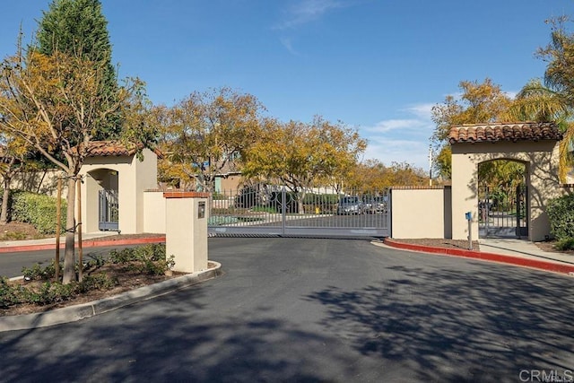 2856 Falling Waters Ct, Chula Vista, CA 91915 - view of asphalt road featuring curbs, a gate, and a gated entry