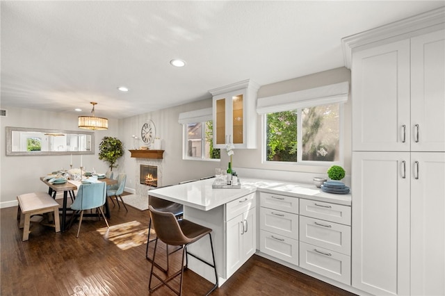1336 Granada St, Upland, CA 91784 - kitchen featuring recessed lighting, white cabinetry, light countertops, dark wood-style floors, and a peninsula