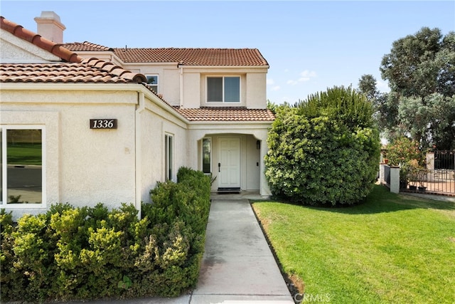 1336 Granada St, Upland, CA 91784 - entrance to property with stucco siding, a tile roof, and a chimney