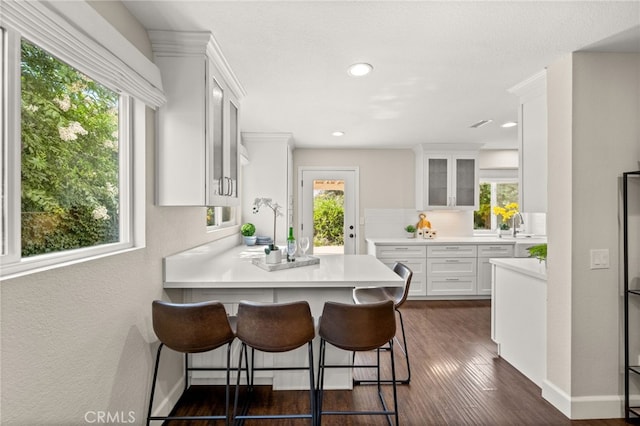 1336 Granada St, Upland, CA 91784 - kitchen featuring white cabinetry, plenty of natural light, a peninsula, glass insert cabinets, and recessed lighting