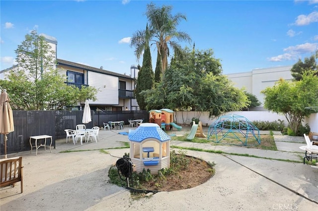 513 N Chandler Ave Unit E, Monterey Park, CA 91754 - view of community featuring a playground, a patio area, a fenced backyard, and outdoor dining area