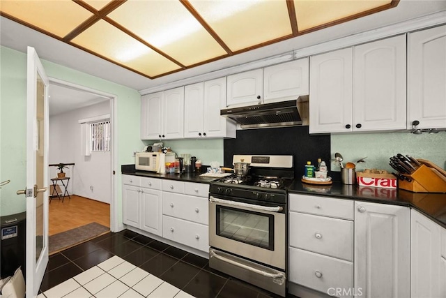 513 N Chandler Ave Unit E, Monterey Park, CA 91754 - kitchen featuring gas stove, white cabinetry, under cabinet range hood, dark tile patterned floors, and dark countertops