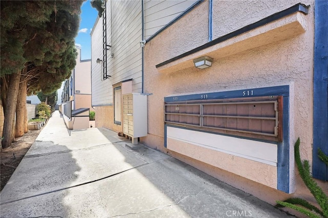 513 N Chandler Ave Unit E, Monterey Park, CA 91754 - view of side of home featuring mail area and stucco siding