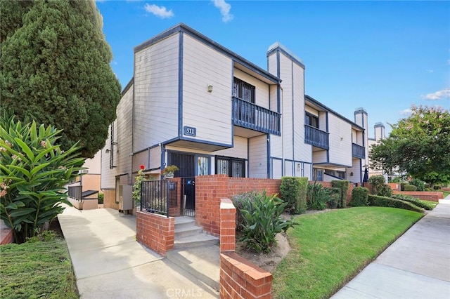 513 N Chandler Ave Unit E, Monterey Park, CA 91754 - view of front facade featuring a front lawn and brick siding