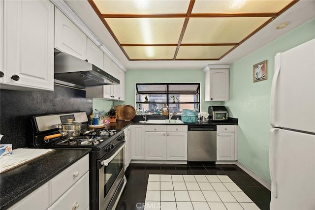 513 N Chandler Ave Unit E, Monterey Park, CA 91754 - kitchen featuring appliances with stainless steel finishes, under cabinet range hood, dark tile patterned flooring, and white cabinetry