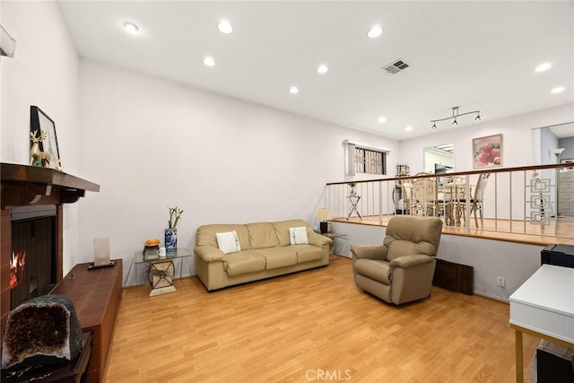 513 N Chandler Ave Unit E, Monterey Park, CA 91754 - living room featuring a lit fireplace, light wood finished floors, and recessed lighting