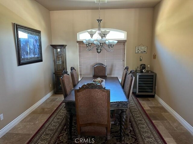17134 Joshua Rd, Apple Valley, CA 92307 - dining area featuring stone tile floors, a chandelier, and beverage cooler