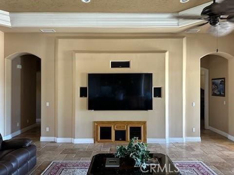 17134 Joshua Rd, Apple Valley, CA 92307 - living area featuring arched walkways, a ceiling fan, stone finish floors, and ornamental molding