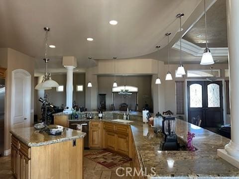 17134 Joshua Rd, Apple Valley, CA 92307 - kitchen with a large island, ornate columns, recessed lighting, light stone countertops, and hanging light fixtures