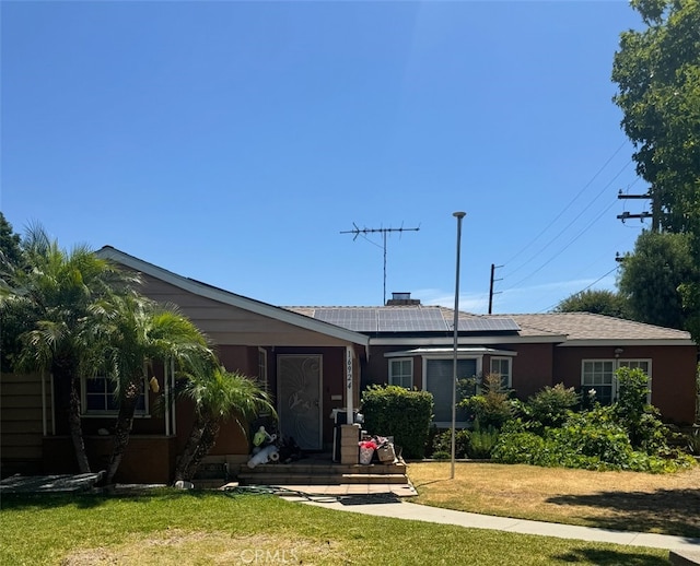 16924 Bixby Ave, Bellflower, CA 90706 - view of front of home featuring a front yard and roof mounted solar panels