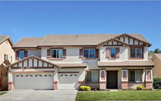 6698 Lake Springs St, Eastvale, CA 91752 - english style home featuring a tile roof, driveway, stucco siding, and a front yard