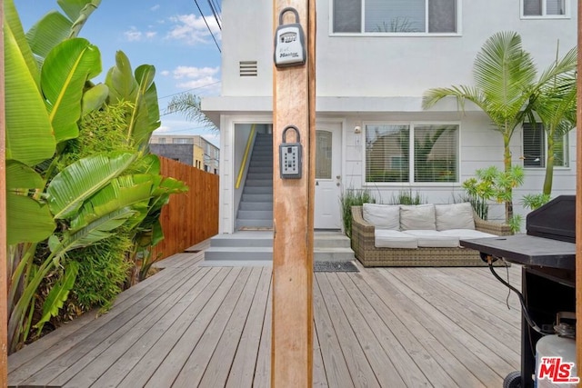 exterior space featuring a wooden deck and an outdoor living space