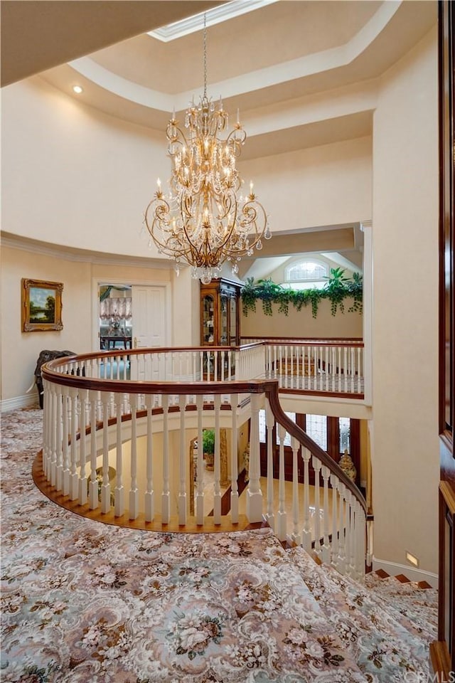 interior space featuring a raised ceiling and a notable chandelier