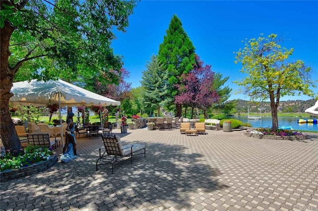 view of terrace featuring a water view and an outdoor living space